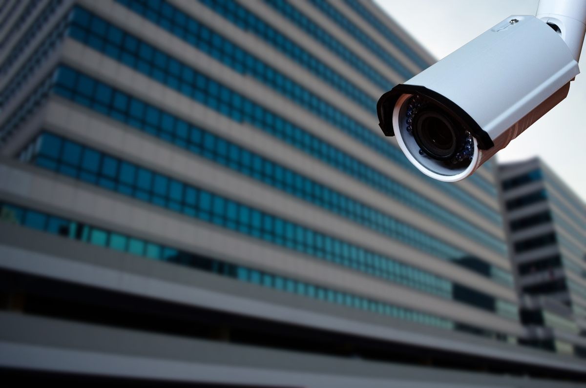 security CCTV camera with blurred office building background.